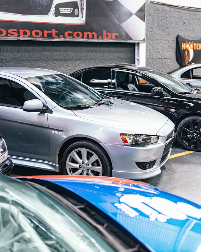 about-us A sleek display of modern vehicles in a well-lit showroom, highlighting automotive design.